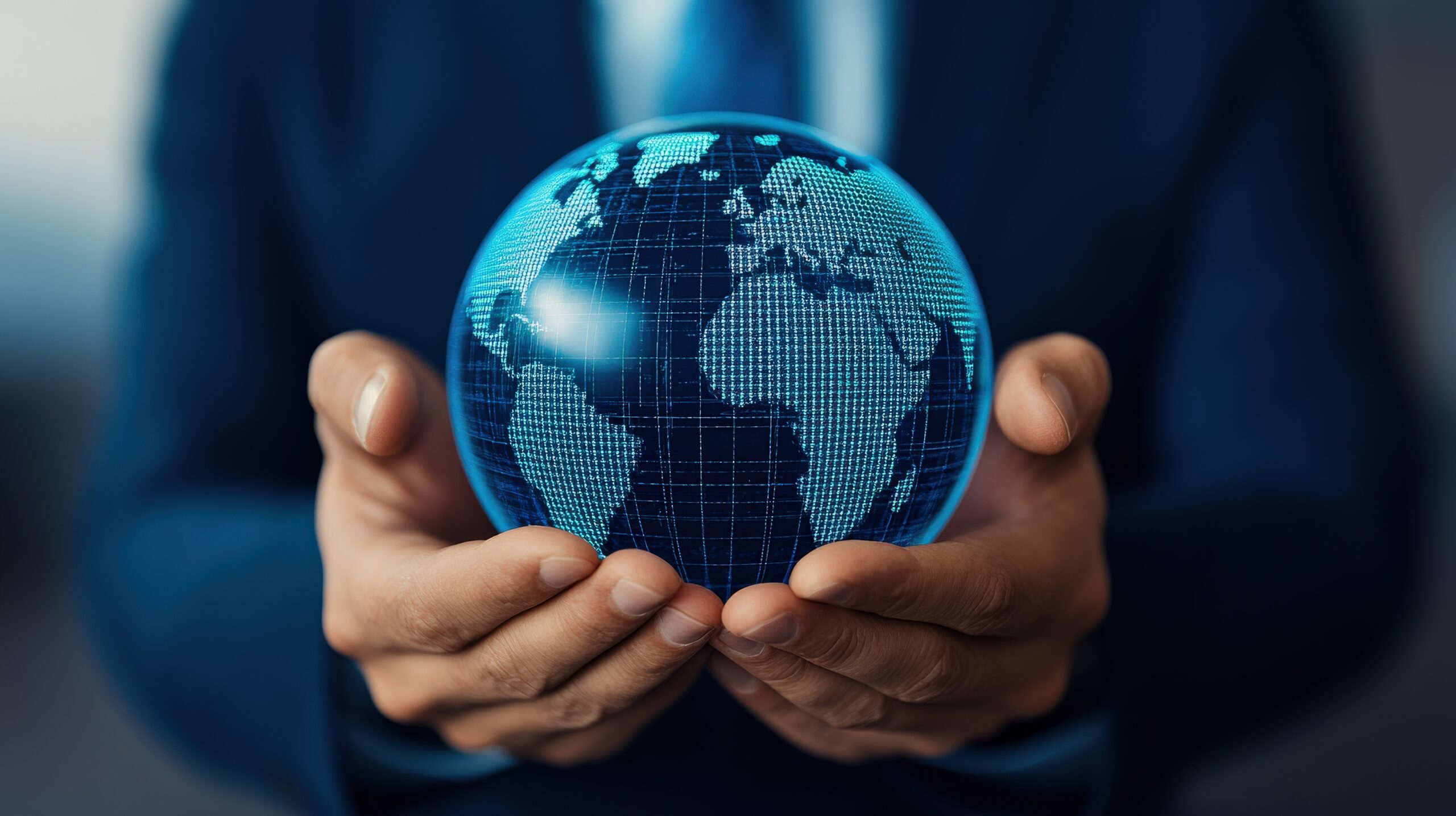 A businessman holds a glowing globe symbolizing global connectivity and innovative solutions in the corporate world.