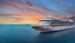 Luxury cruise ship sailing to port on sunrise